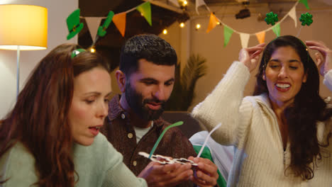 Group-Of-Friends-Dressing-Up-With-Irish-Novelties-And-Props-At-Home-Or-In-Bar-Celebrating-At-St-Patrick's-Day-Party